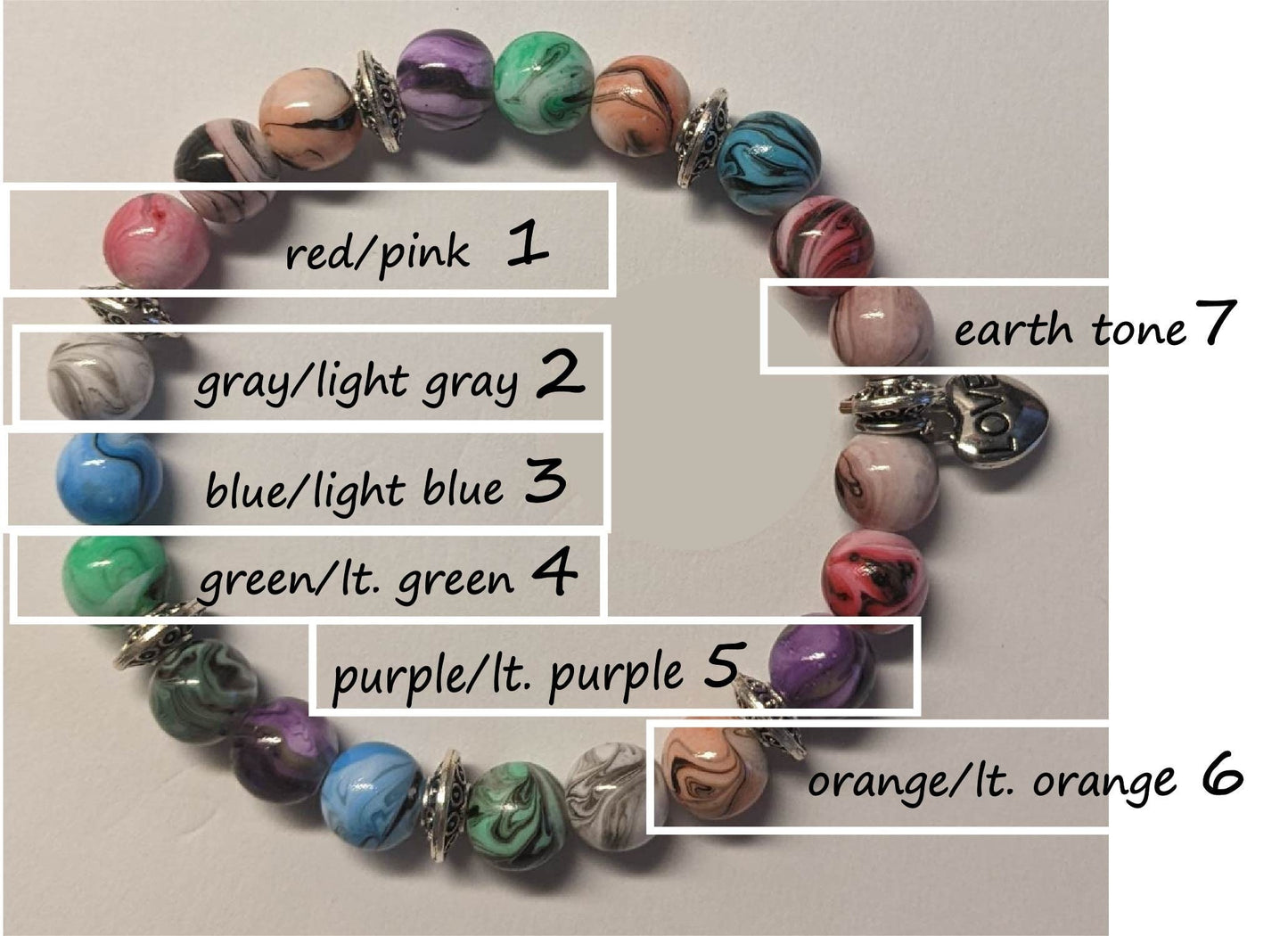 Bracelets - stacker bracelets made with 8-mm multi-colored ink patterned beads, spacer beads, a charm, and durable stretch cord.
