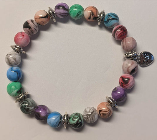 Bracelets - stacker bracelets made with 8-mm multi-colored ink patterned beads, spacer beads, a charm, and durable stretch cord.